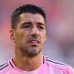 Suarez sorry for spitting at opposition coach