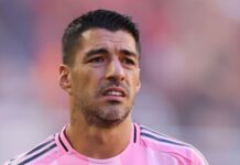 Suarez sorry for spitting at opposition coach