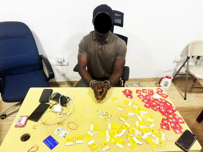 Jesper-Kobina-Mensah-the-accusedd-with-some-SIM-cards-and-others-used-in-committing-the-allaged-crime--1024x768
