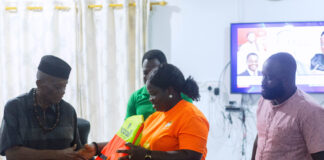 Oti Regional Minister, John Kwadwo Gyapong being presented with some life jackets