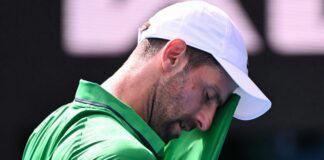Djokovic scrapes into semis after Musetti injury