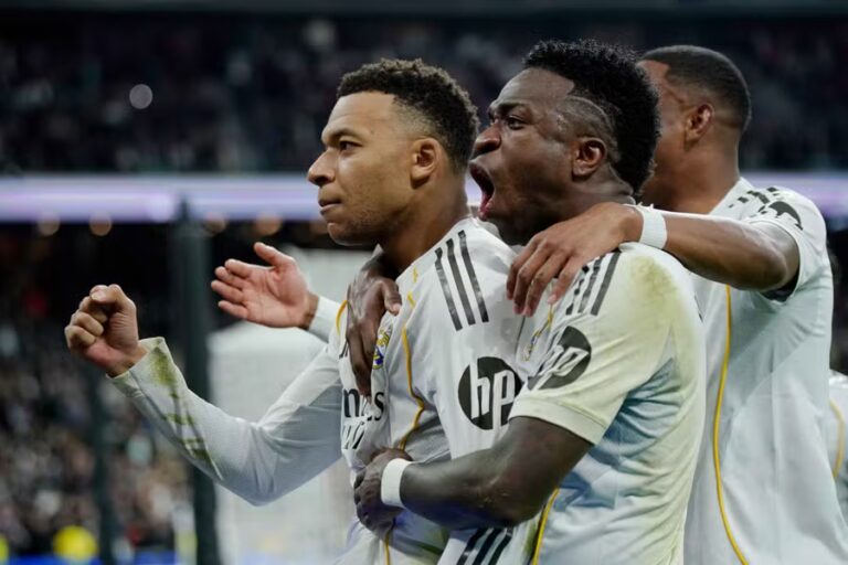 Real Madrid edge past nine-man Rayo Vallecano through 99th-minute penalty from Mbappe