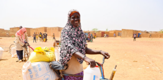 Mother-of-six Zourata after receiving food aid from the World Food Program in May 2024, in Titao, Burkina Faso. Photo: WFP/Emily Pinna