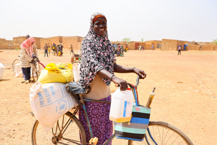 Mother-of-six Zourata after receiving food aid from the World Food Program in May 2024, in Titao, Burkina Faso. Photo: WFP/Emily Pinna