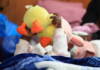 A migrant child plays with her toy while sheltering in a hall with her family, following an escalation in anti-immigrant protests, in Kleinmond, South Africa