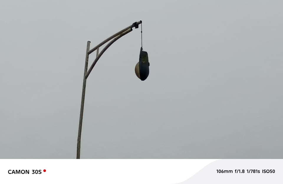 Hanging streetlight in front of Ajumako Education Directorat