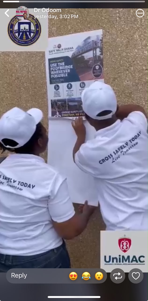 Placing a poster on using the Footbridge at a vantage location in Accra