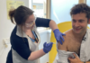 First person gets new experimental vaccine for Ebola