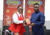 Diana Antwi Hamilton being presented with a satchet of Onga Tomato Mix