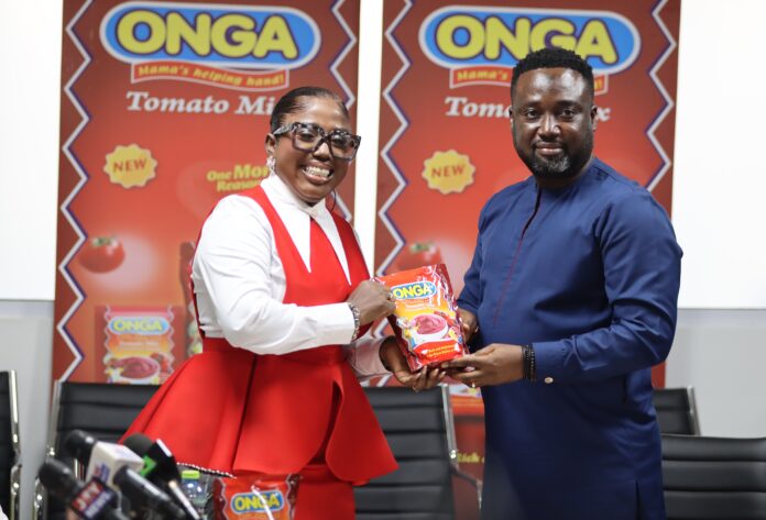 Diana Antwi Hamilton being presented with a satchet of Onga Tomato Mix